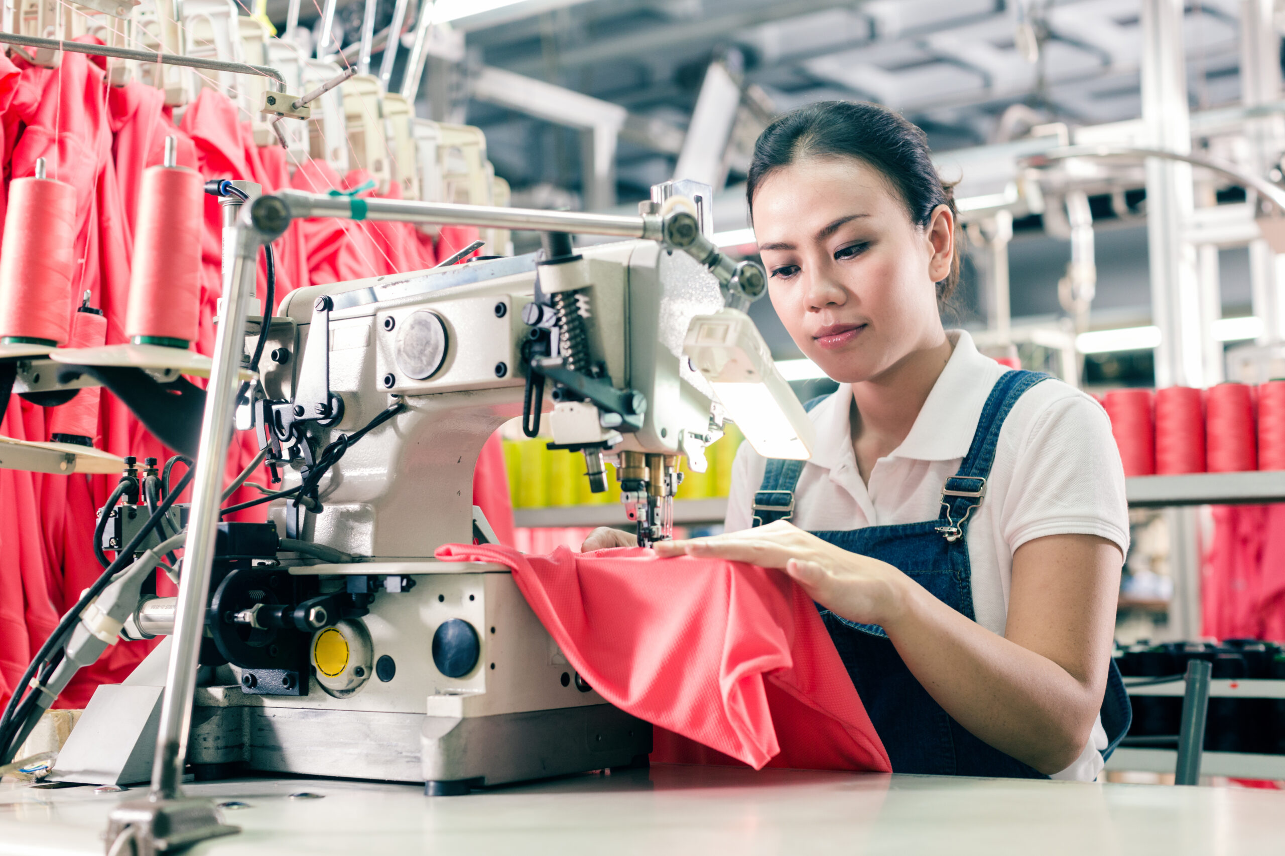 Seamstress,Or,Worker,In,Asian,Textile,Factory,Sewing,With,Industrial